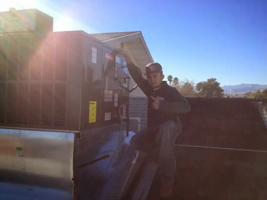 HVAC technician performing HVAC Inspection on a rooftop unit in Lake Oswego